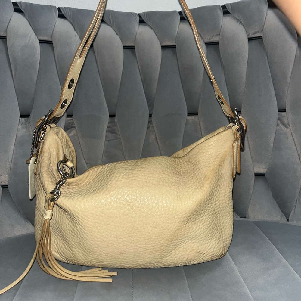 Coach east west tassel pebble leather color beige